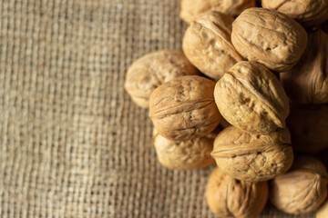 walnuts over jute fabric and a wooden cutting board	