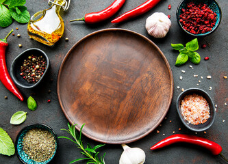 Empty wooden plate and frame of spices
