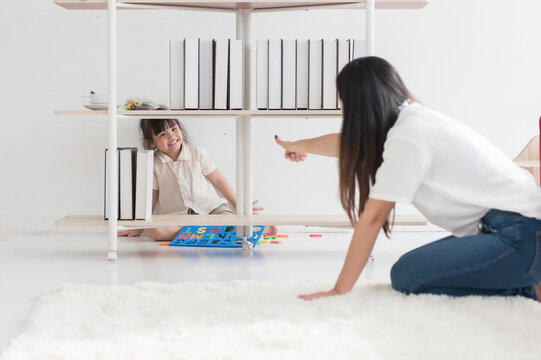 Young Asian Mother And Daughter Play Hide And Seek In The House. Spend Free Time Creating Good Relationships In The Family On Vacation Or Holiday Weekend, Family Concept