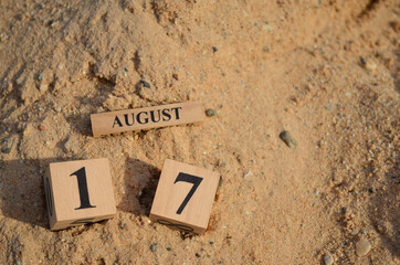 August 17, Number cube with Sand pile for a background.