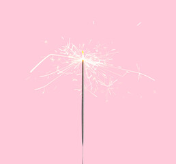 Beautiful sparkler burning on pink background. Party decor