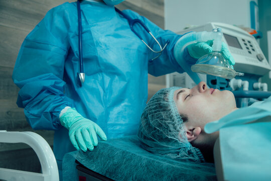 Medical worker giving general anesthesia to the patient
