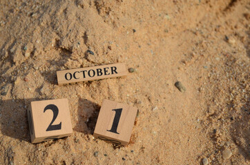 October 21, Number cube with Sand pile for a background.