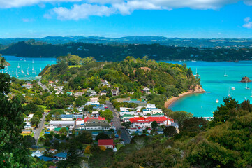 Russell Island panorama, Bay of Islands near Paihia, New Zealand, Scenic landscape of rural town and harbor with boats and yachts in clear turquoise water of the ocean, View from Flagstaff Hill
