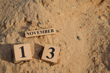 November 13, Number cube with Sand pile for a background.