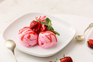 Plate with tasty strawberry ice cream on white background