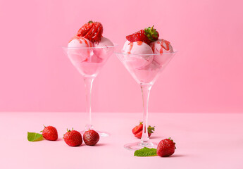 Glasses with tasty strawberry ice cream on color background