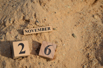 November 26, Number cube with Sand pile for a background.