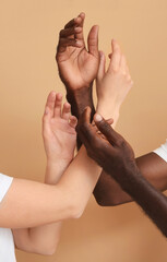 Hands of Caucasian woman and African-American man on color background. Racism concept