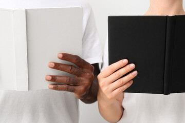 Caucasian woman and African-American man with books, closeup. Racism concept