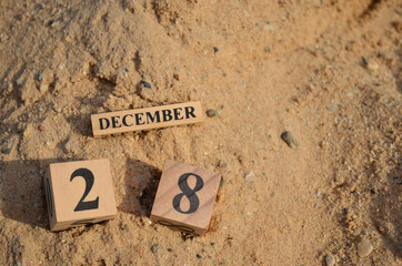 December 28, Number cube with Sand pile for a background.
