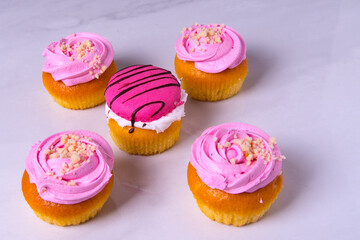Beautiful pink cupcakes, cakes, on a light background, close-up