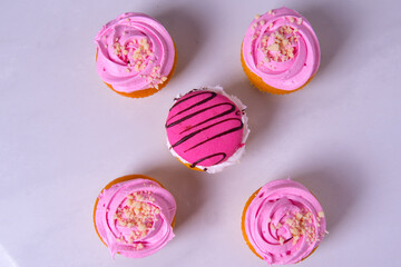 Fototapeta na wymiar Beautiful pink cupcakes, cakes, on a light background, close-up
