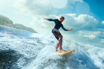 Surfer on Blue Ocean Wave Getting Barreled. 