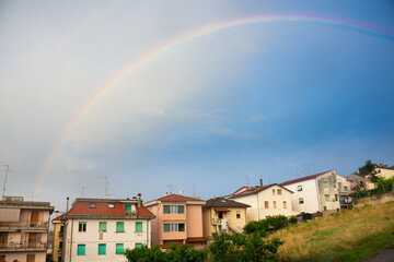 Rainbow over houses of a small town