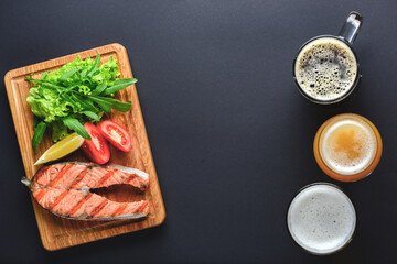 Grilled salmon steak with sea salt and pepper. Fresh fish. Top view, copy space. Food background. Alcohol drinks.