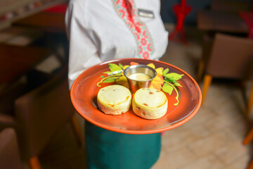 Cheesecakes with cottage cheese served on a ceramic plate. Ukrainian cuisine, Ukrainian concept.