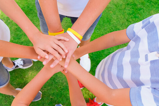 Friends or brothers putting their hands together in a sign of unity and teamwork. Friendship concept. Family concept.
