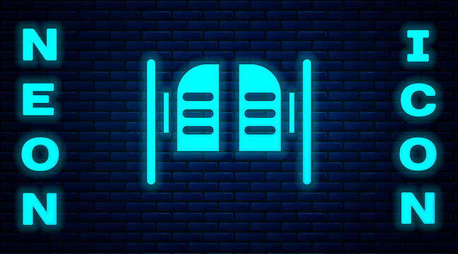 Glowing neon Old western swinging saloon door icon isolated on brick wall background. Vector Illustration.