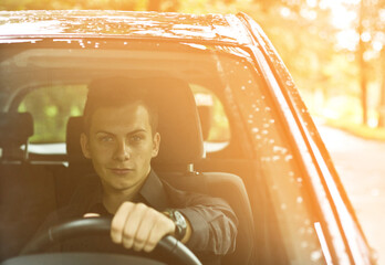 Front view. Portrait of a handsome man driving his car.