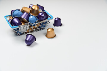 Close up colourful capsules or pods for coffee mashine in shopping basket 