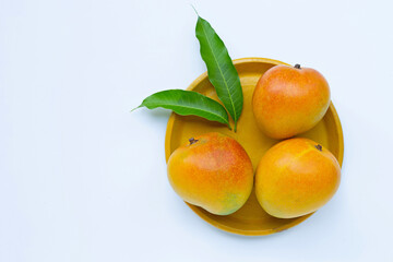 Tropical fruit, Mango on yellow plate on white background.