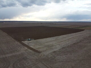 Agricultural machinery in the field, aerial view. Agricultural work.