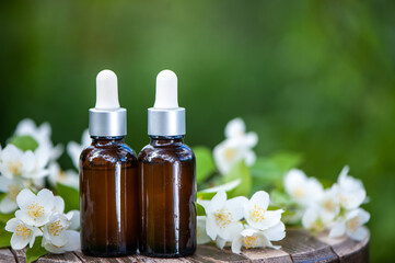 Fototapeta na wymiar Essential Jasmine oil. Bioproduct, organic cosmetics. Perfumery, cosmetology, aromatherapy