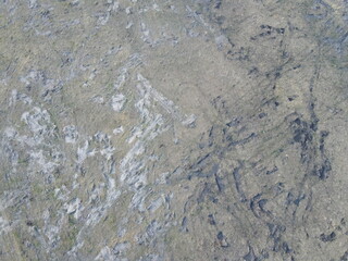 Traces of construction equipment on the soil, aerial view. Lifeless land, wasteland.