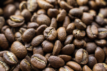 Full frame of aromatic roasted specialty coffee beans background