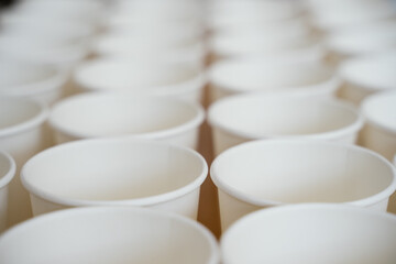 Coffee paper cups in a row. Background coffee to go.