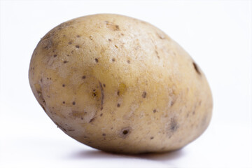 Potato isolated on white background with shadow. Narrow depth of field, background image