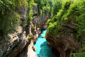 Mountain gorge & river. Beautiful landscape featuring mountain river sandwiched between towering cliffs gorge. Amazing scenic vivid turquoise river stream rapids, running through mountain gorge forest
