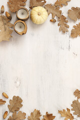 Autumnal still life with oak leaves, acorns, pumpkin and candles