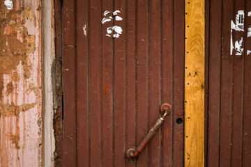 fragment of a wooden door with an antique handle in a vintage building