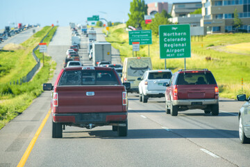 Heavy traffic along a main US interstate, cars queued on both paths