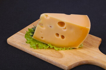 Maasdam cheese  in the board served salad leaves