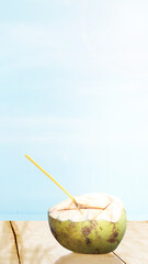 Coconut fruit on the table with ocean view background