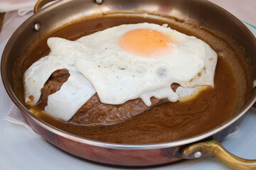 Delicious meat dish from Portugal food - juicy tenderloin steak with fried egg served in thick wine sauce