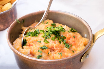 Delicious side dish from Portugal cuisine - mashed sweet potato puree with fresh tomato, garlic, herbs and sour-cream