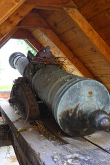 old  cannon with a nest and pigeon