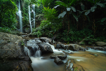 Naklejka na ściany i meble Tropical waterfall in rain forest at Mokfa Waterfall, Chiang Mai in North Thailand.
