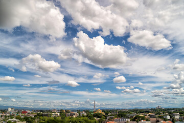 White clouds moving fast over city buildings in Chiang Mai City, North Thailand.