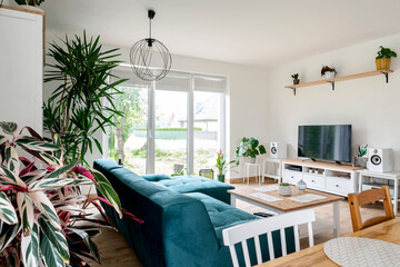 Modern living room with dining table in scandinavian interior. Comfortable sofa 