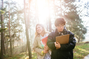 Scientists are studying plant species and inspect trees in the forest.