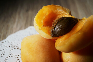 Apricots with napkin on a wood background. Macro panorama.