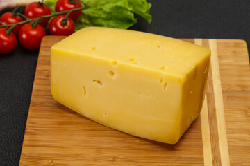 Hard yellow tasty cheese brick