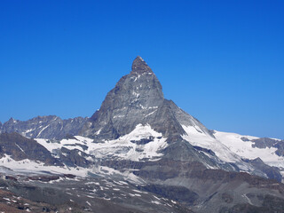 Matterhorn seen from the mountain climbed by the train in Zermatt on a sunny day.