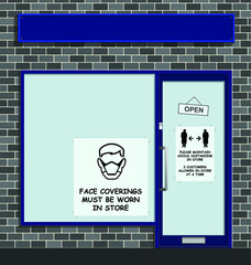 Face coverings to be worn in store sign in shop window following new government guidelines to combat the spread of COVID 19 with blank sign for own text