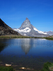 Matterhorn seen from the mountain climbed by the train in Zermatt on a sunny day.